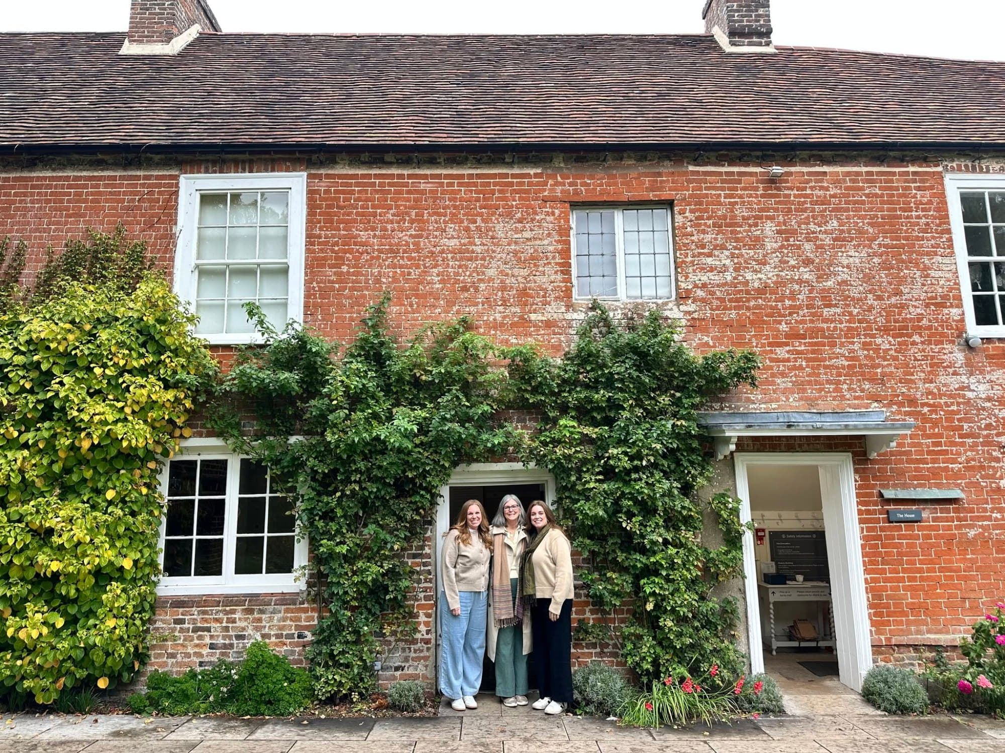 3 women standing in the doorway of Jane Austen's house in Chawton